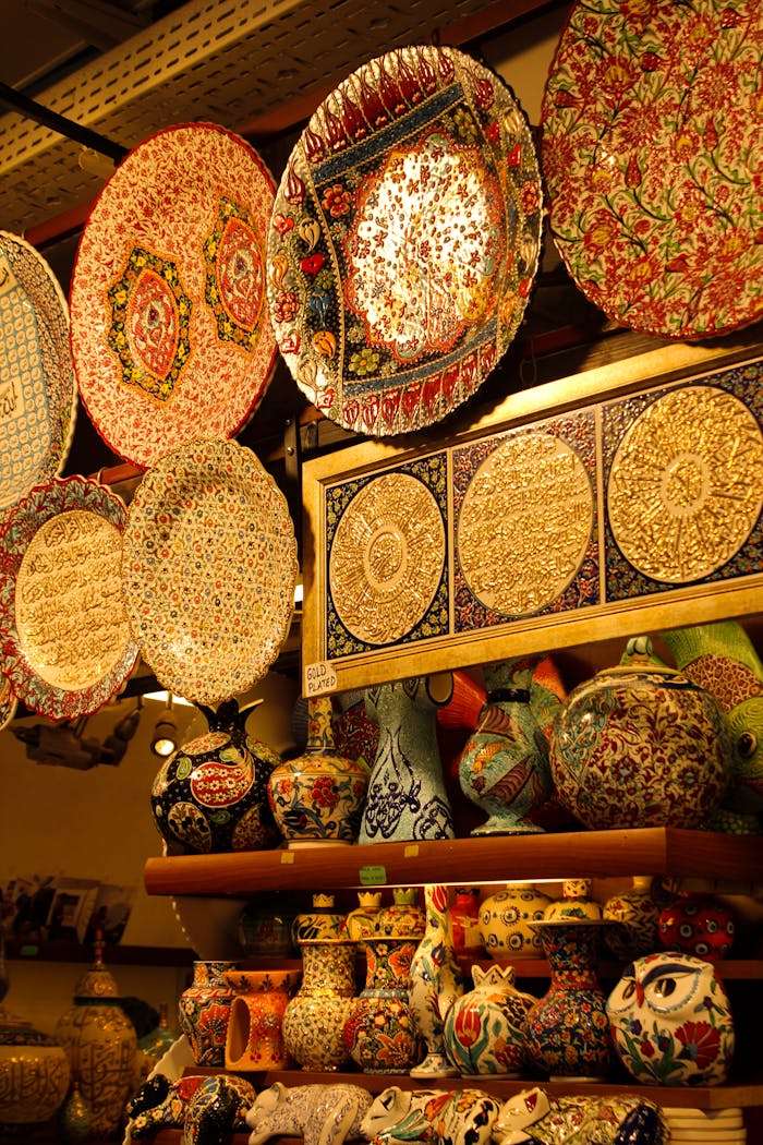 Vibrant display of handmade ceramic plates and vases with intricate patterns in a shop.